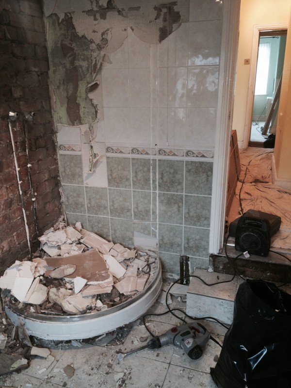 Knocking tiles off wall Beamans Bathrooms